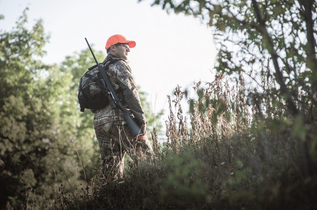 The Ruger American is ideal for trekking, and might save you enough money for a decent pair of boots.