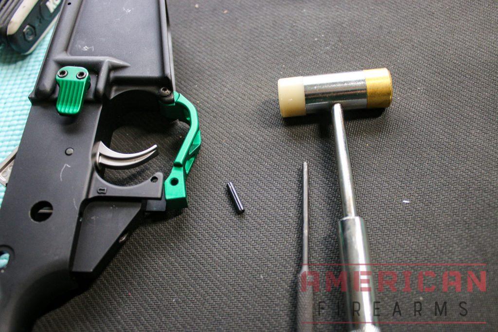 First, line up the trigger guard with the holes on the lower.